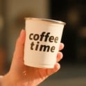 A sample image of a hand holding a white cup with the words Coffee Time printed on it