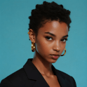 A small size picture of a black woman model wearing black suit